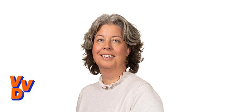 Portrait of den Hollander with logo VVD.