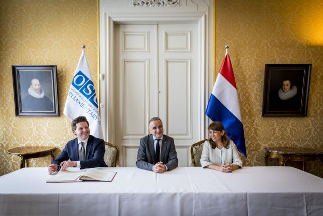 A document is signed during the first OVSE PA meeting.